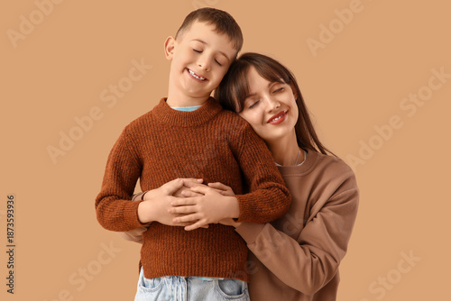 Happy mother hugging her li...