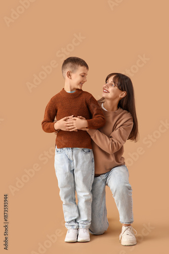 Happy mother hugging her li...