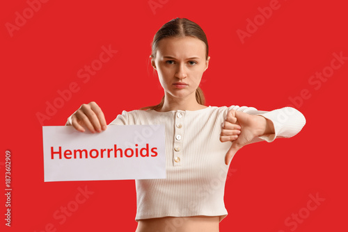 Young woman holding paper w...