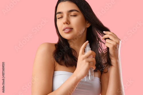Young woman applying hair s...