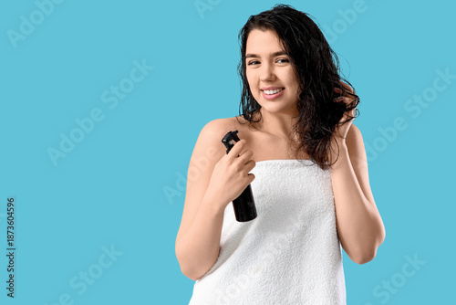 Young woman with hair spray...