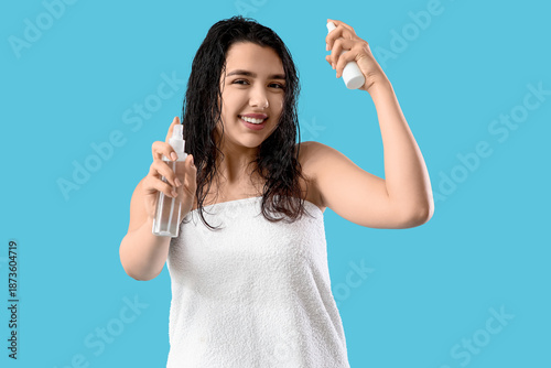 Young woman with hair spray...