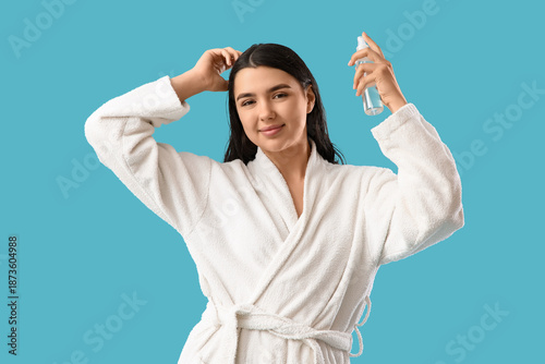 Young woman in bathrobe app...