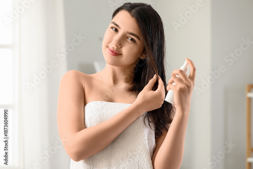 Young woman applying hair s...