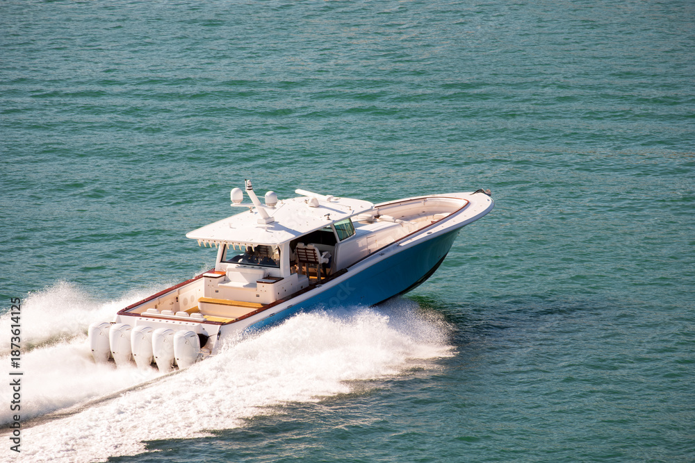Fototapeta premium Luxury Fishing Motor Yacht With Five Outboard Engine Cruising at High Speed