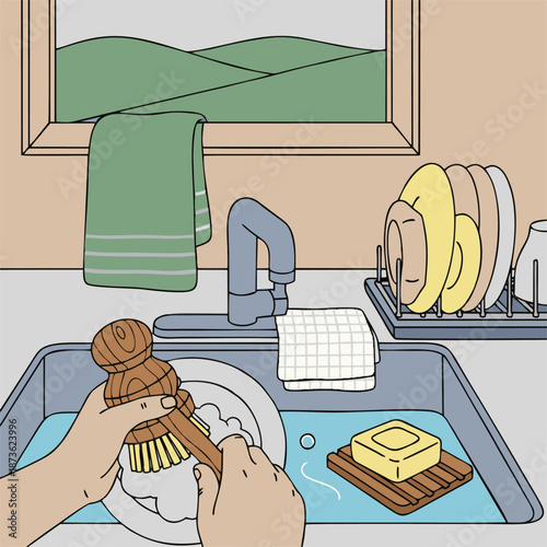 Hands washing dishes with a wooden brush in a kitchen sink.