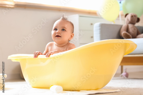 Little baby in bathtub at home