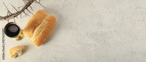Tableau sur toile Cup of wine with bread and crown of thorns on light background