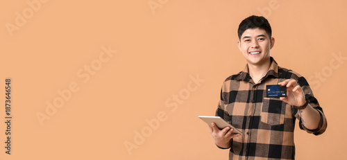 Asian man with credit card ...