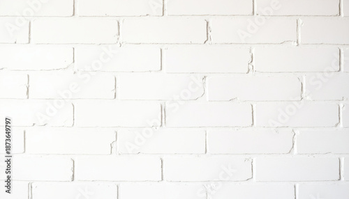White painted brick wall in a minimalist style in white colors acting as a clean texture background with copy space