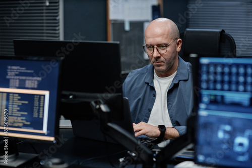 Photography Middle aged Caucasian man working at computer station in modern office, focusing