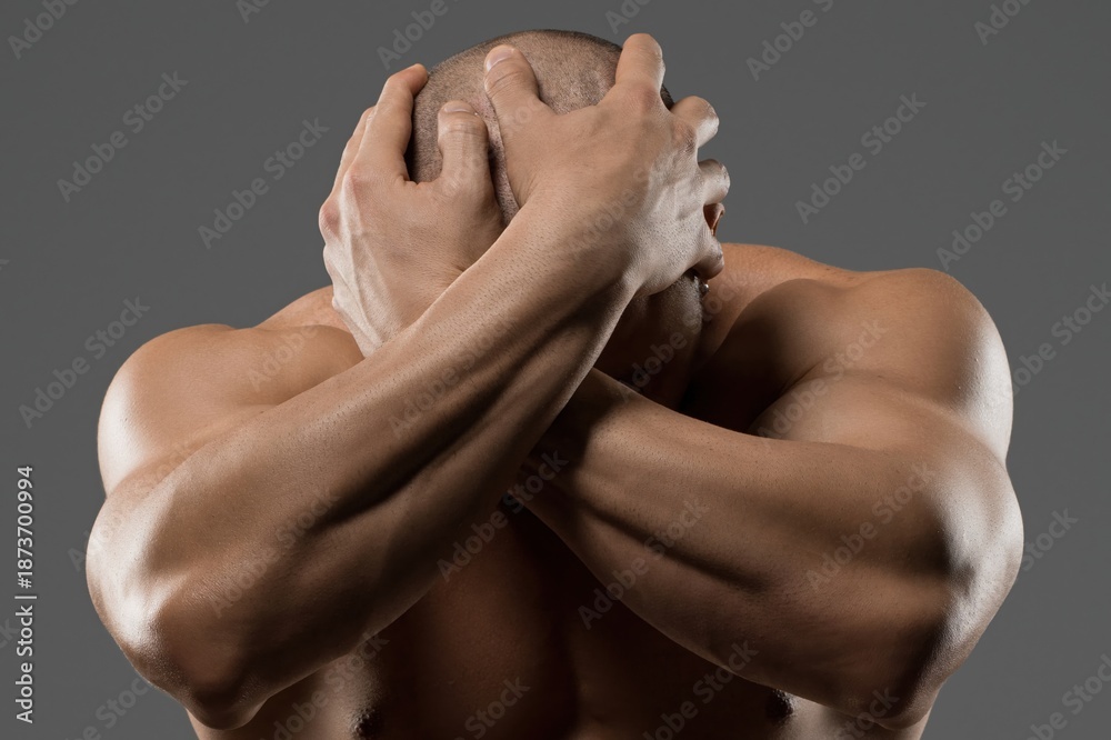 custom made wallpaper toronto digitalStrong man covers face with hands expressing deep emotion in a neutral setting
