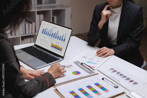 Businesswomen analyzing financial data and marketing reports