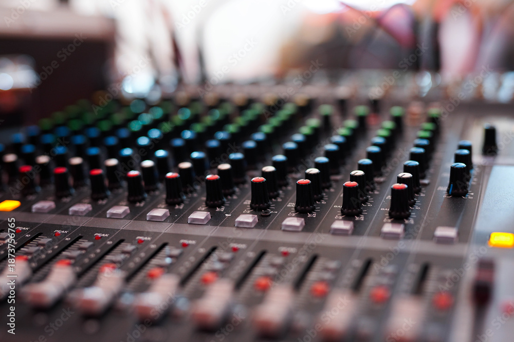 Fototapeta premium Professional Audio Mixing Console with Colorful Knobs and Sliders