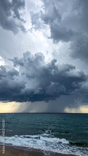 Dramatic seascape with dark clouds and heavy rain falling