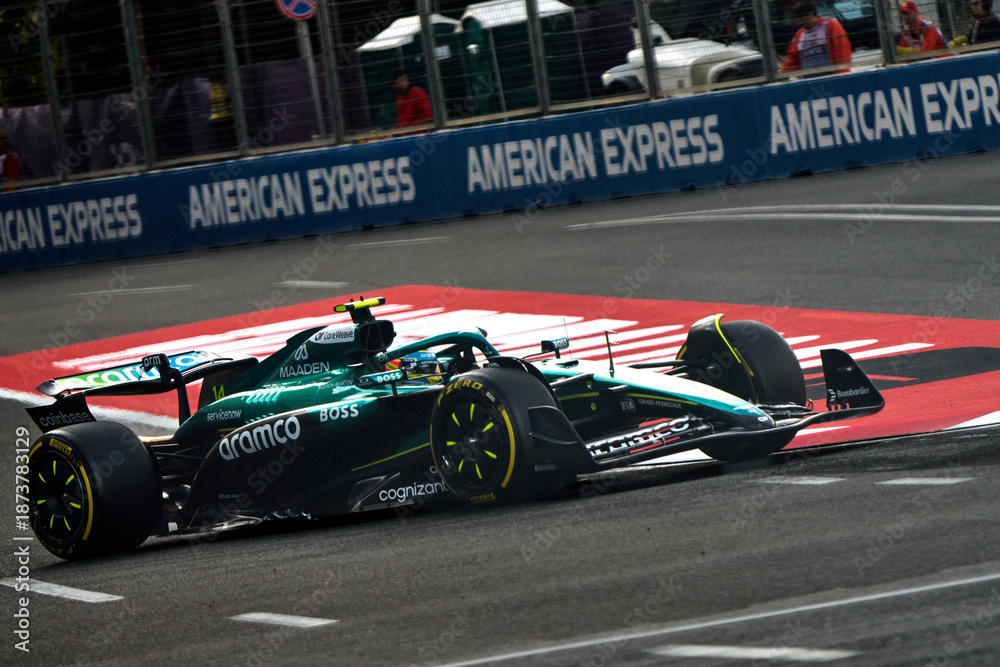 Fototapeta premium BAKU, AZERBAIJAN - SEPTEMBER 20, 2025: Fernando Alonso drives the Aston Martin Aramco Formula One Team car during a practice session at the Baku City Circuit for the 2025 Azerbaijan Grand Prix