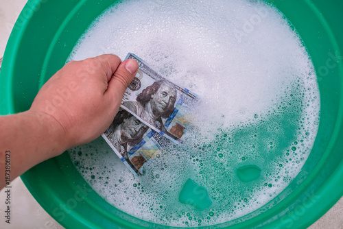 Conceptual. Symbolic money laundering in a basin of soapy water