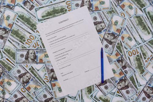 An empty contract lies on a pile of money, ready for signing and filling out