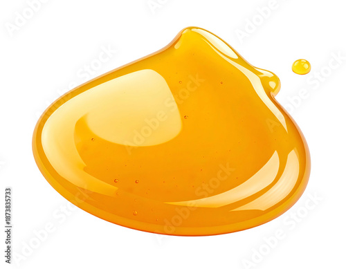 Close-up of golden, viscous fluid blob against black background