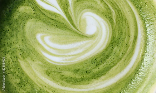 frothy matcha latte with its signature vibrant green color and delicate swirling foam patterns