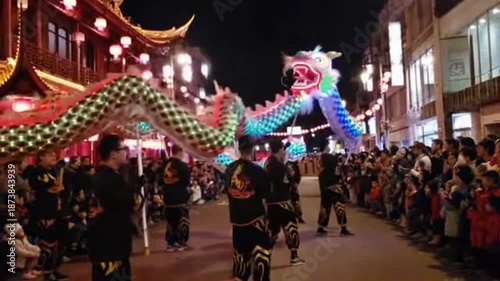 A vibrant dragon dance performance on a bustling street at night with a large crowd watching in a city with traditional lanterns