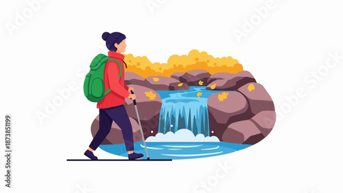 Hiker with backpack walks near a waterfall and rocks in autumn