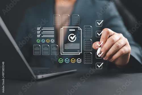 Businessman checking off a digital checklist on a virtual interface, representing task management, workflow optimization, productivity, audit, compliance, and digital transformation.