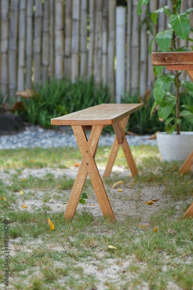 Fototapeta premium Small Wooden Folding Stool on Pebbled Ground