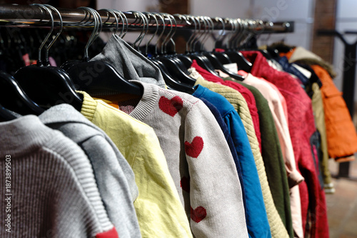 Assorted Vintage and Second Hand Clothing on Hangers in a Thrift Store © Fox Bread