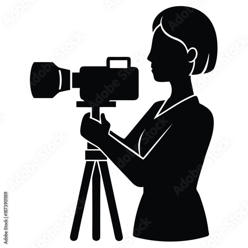 Silhouette of a woman holding a professional video camera on a tripod with a lens attachment