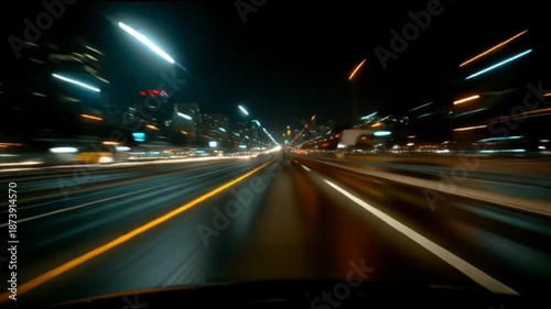 Video from the front window of a car speeding on a highway through night city in lights