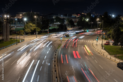 Canvas Print Night city traffic captured with long exposure showing dynamic light trails on a wide urban road in Athens, Greece