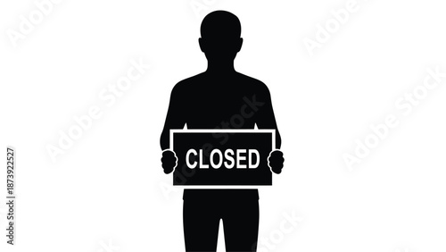Silhouette of a person holding a sign that reads closed