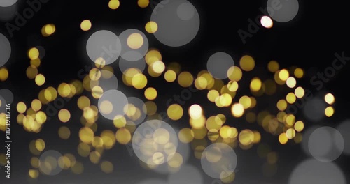 Golden bokeh lights animation over dark background