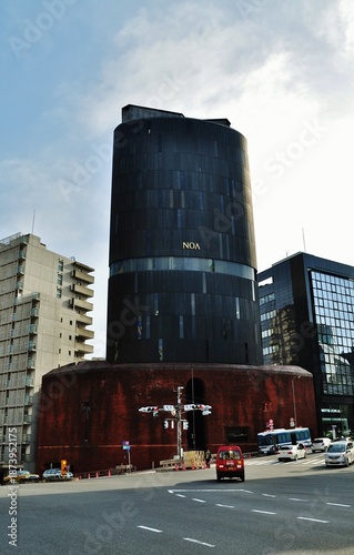 Traffic at Iikura Katamachi intersection with NOA Building, Tokyo, Japan