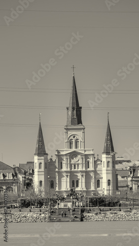 Historic St Louis Cathedral rising above New Orleans skyline along Mississippi River