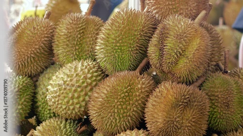 Durians displayed on fruit showcases at a fruit stall in asia traditional market