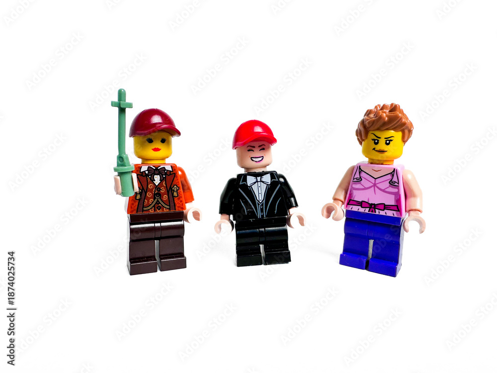 Obraz premium Three Colorful Lego Mini Figures in Various Attires with Accessories
