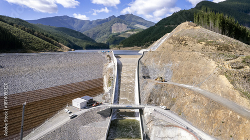 Lee Valley, New Zealand - 24 January 2024: Aerial view of the dam's stark concrete against the rugged hills, a testament to engineering amidst nature's grandeur.