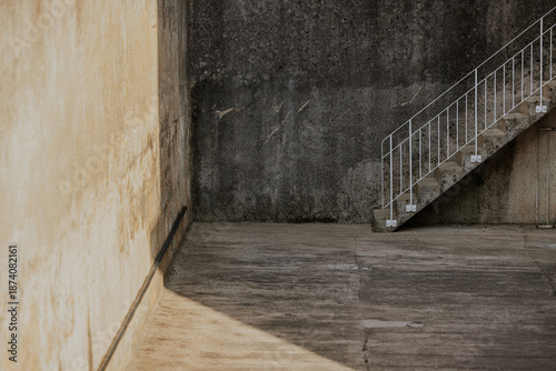 Concrete stairway with textured walls and shadows