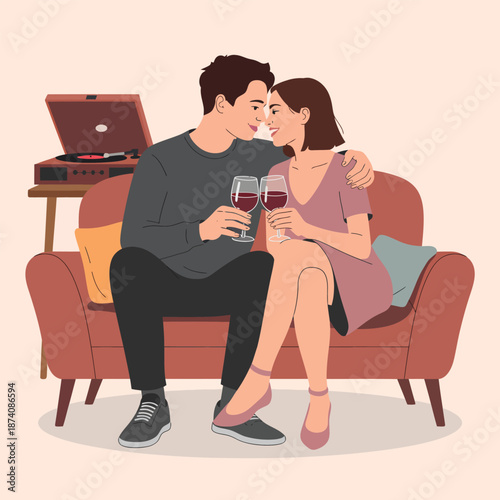 A loving couple enjoys a romantic evening at home, toasting with red wine and listening to music