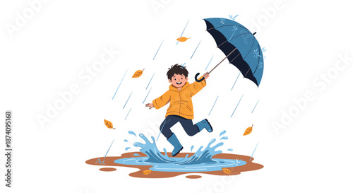 Happy boy wearing a yellow raincoat and blue boots jumps into a large water puddle with a blue umbrella on a rainy autumn day.