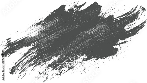 Broad dark grey brush stroke with visible texture and fine ink splatters forming an abstract artistic background for creative