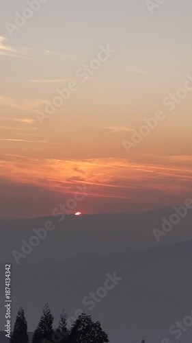 4K sunset over hills with warm orange sky, close up sunset view over distant hills.warm orange sky.
