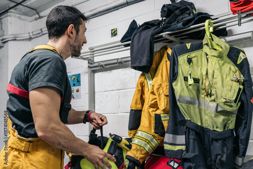 Φωτογραφία Firefighter preparing equipment in fire station locker room