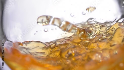 Apple juice is poured into a glass, creating a beautiful wave. High quality 4k footage