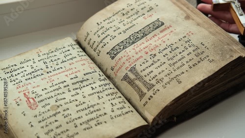 Turning through pages of Slavic Gospel, old pages with candle wax stains, Orthodox holy Bible for Christians, psalter with psalms. Cyrillic Church Slavonic. 
