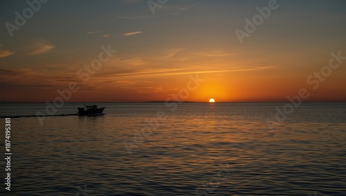 Lone boat silhouette on the ocean at sunset with amber hues, highlighting peacefulness and isolation