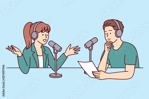 Female host recording audio content while her male partner listens intently. Professional team of creators discussing news and stories for digital broadcast in studio.
