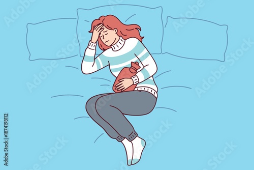 Young woman lying on bed in distress holding her head and abdomen. Concept of endometriosis migraine or menstrual cramps causing severe pain and fatigue in female body